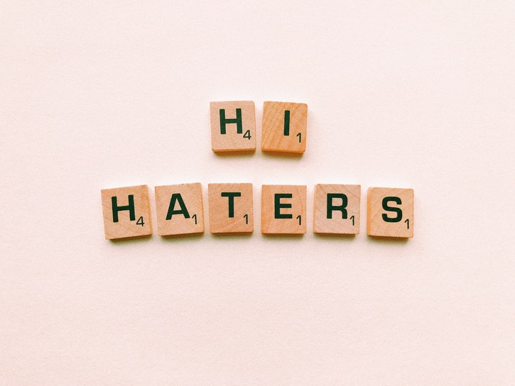 Scrabble letters arranged to spell "Hi Haters".